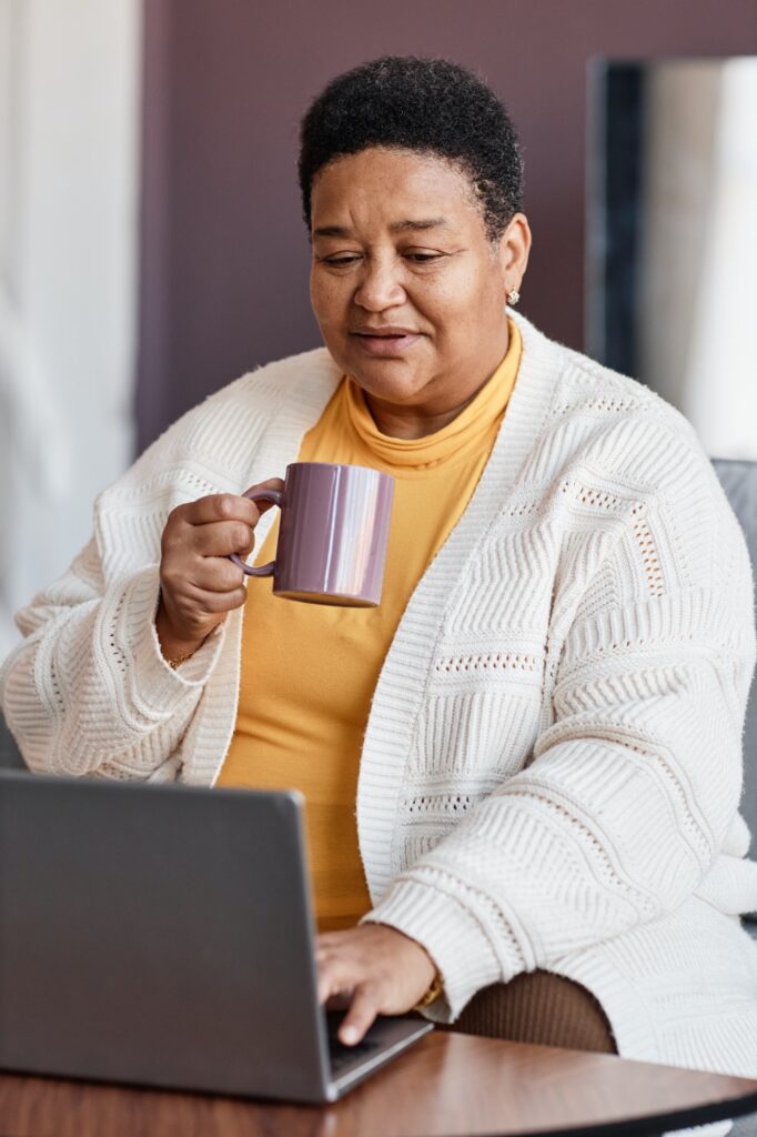 Senior black woman using laptop at home